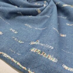 Plavi jeans s poderanim izgledom i šarenim nitima